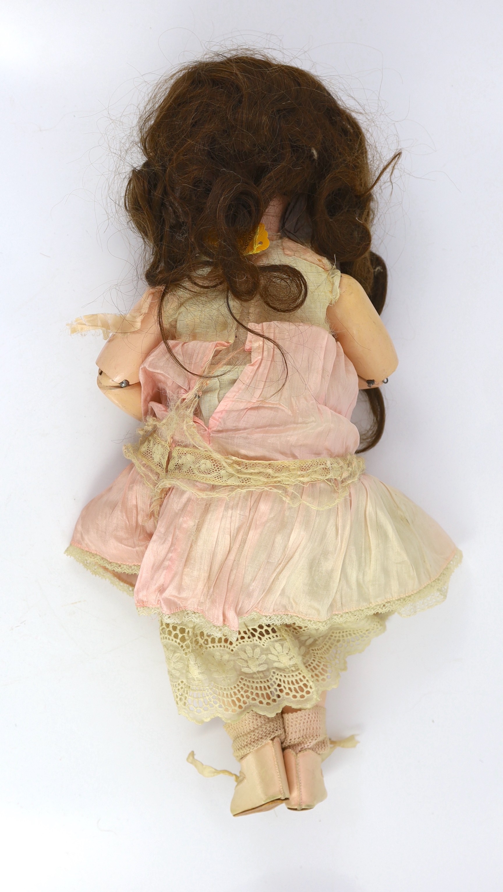 A rare Simon & Halbig walking kiss-blowing bisque doll, German, circa 1891, 22in.